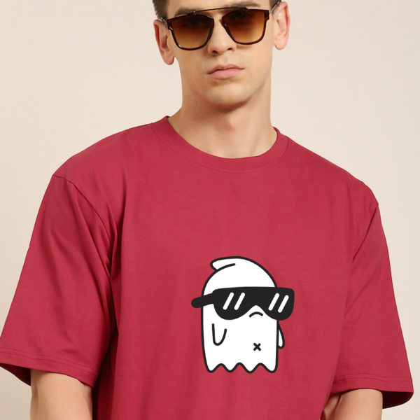 A young model rocks a relaxed-fit, red oversized tee with a ghost wearing a spec in the center.